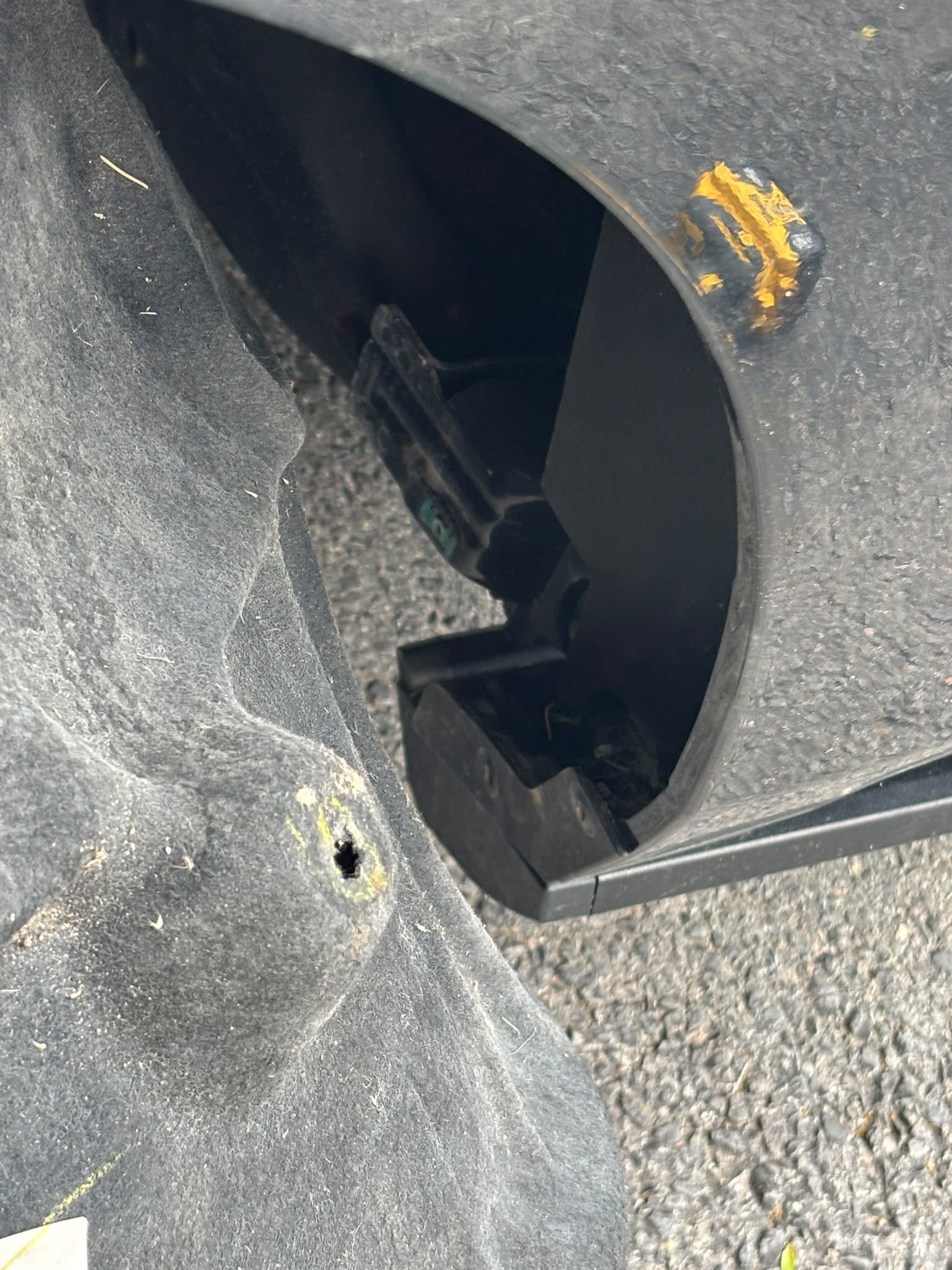 Recovery #2 — install signature: yellow tape residue + cavity hole where the device was hidden